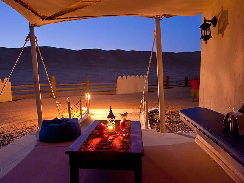 Inside shot of tent lit by lanterns in the evening